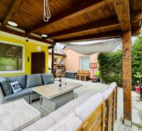 Cottage on Trnkova 213 in Bžany with a terrace, rattan furniture, and an outdoor fireplace.
