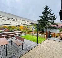 Cottage on Trnková 213 in Bžany with a gazebo, bench, and a view of the gardens.