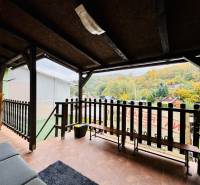 A veranda at the cottage in Bžany on Trnková 213 with a view of the wooded hills.