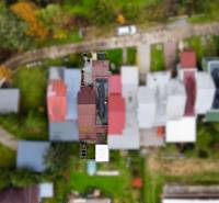 An aerial view of the roofs of cottages on Trnková Street 213 in Bžany surrounded by greenery.
