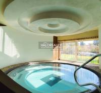 Interior dining spaces with a pool and garden view.