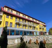 Yellow building with balconies, surrounded by greenery in Dudince, Gastro premises.