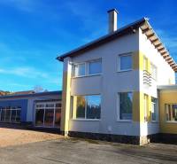 A family house in Necpaly, colorful facade, large yard, sunny bright day.