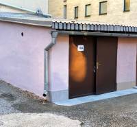 Garages on Mlynska Street in Košice - Staré Mesto district with light purple plaster.