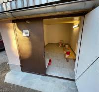 An open garage on Mlynská in Košice - Staré Mesto district, with tools and a bucket.