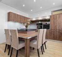 A kitchen in a 2-room apartment with wooden decor furniture and light walls.
