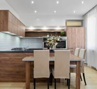 A kitchen in a 2-room apartment with wooden decor and light furniture.