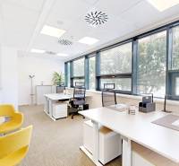 Offices with modern equipment, comfortable chairs, and large windows letting in natural light.