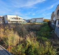 Residential land in Bytča with buildings and paved area.