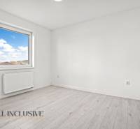 A room in a 2-room apartment with a window and a floor with a wooden decor.