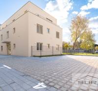 Building on Železničná Street in Bratislava - Vrakuňa with an adjacent parking lot.