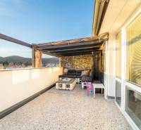 Terrace with seating, view of the rooftops and hills in a 2-room apartment on Vajanského in Modra.