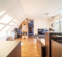 Living room in a 2-room apartment with a wooden decor floor and a brick fireplace.