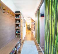A hallway in a 2-room apartment with a wooden decor floor and storage space.