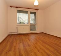 A room in a 3-room apartment with a wooden decor floor, the space is empty.