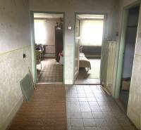 Interior of a family house with a hallway and entrances to rooms, floor with wood decor.