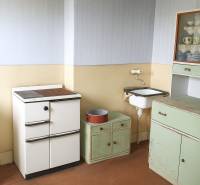 A kitchen in a family house with retro furniture and a sink.