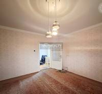 A room in a family house with carpet flooring and pendant lighting.