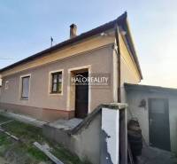 A family house in Dvory nad Žitavou with a plastered facade, exterior stairs, and a courtyard.