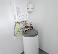Bathroom equipment in a family house with a boiler and water heater in a neutral room.