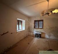 A room in a family house with a panel floor, old lighting, and a radiator.