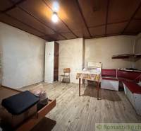 Interior of a family house with a bench and table, floor with wooden decor.