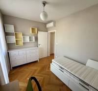 A room in a 3-room apartment with light furniture and a wood-decor floor.