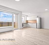 A bright interior of a 2-room apartment with a kitchen, a glass wall, and a floor with a wooden decor.