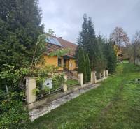 A family house on Sapietova Street in Gbeľany surrounded by greenery and a fence.