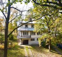 A cottage on Gazárka Street, Šaštín-Stráže, surrounded by trees and a parked car.