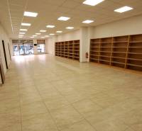 Commercial premises for rent on Mostová Street in Ružomberok, with shelves and flooring with a wooden decor.