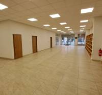 Commercial space with tiles, shelves, and glass doors for entry.