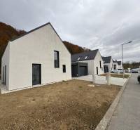 A family house on Pod Drieňovou Street in Kamenica nad Cirochou, terraced housing with cars.