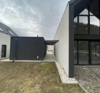 Family house on Pod Drieňovou in Kamenica nad Cirochou with glass surfaces and gravel paths.