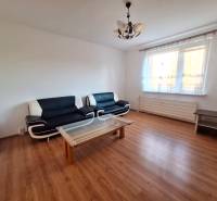 Living room in a 3-room apartment with sofas, a coffee table, and a wooden decor floor.