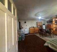 An interior with wooden furniture, a carpet, a table, and a cabin provides a rustic atmosphere.