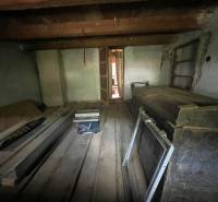 The cottage offers a cozy, traditional interior with a wooden ceiling and floor.