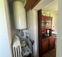 A cottage with a wooden decor floor, a boiler, and storage space in Šípkov.