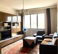 Living room in a 3-room apartment with furniture, a carpet, and a large window.