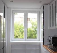 A kitchen in a 3-room apartment with a bright window and modern appliances.