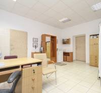 Offices with furniture and a sink, a bright space with tiled flooring.