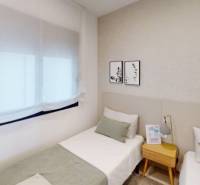A room in a vacation apartment with two single beds and subtle wall decorations.