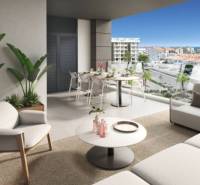A balcony of a holiday apartment in Torrevieja with a view of the city and the sea.