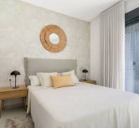 Bedroom in a holiday apartment, bed, nightstands, large window.