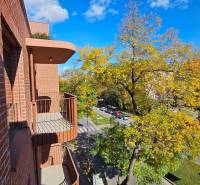View from the balcony of a brick house onto the street in Bratislava - Ružinov, Košická.