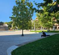 Park in Bratislava - Ružinov with people relaxing on benches on Košická Street.
