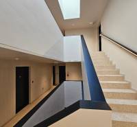 A staircase with terrazzo steps and a bright ceiling in a 3-room apartment.