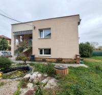 A family house on Topoľová Street in Sereď with a decorative garden and a pond.