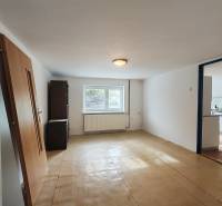 A room with a wooden floor decor in a family house, exit to the kitchen.