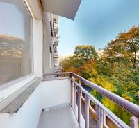 The balcony of a 2-room apartment on Krížna Street, surrounded by trees in Bratislava - Staré Mesto.